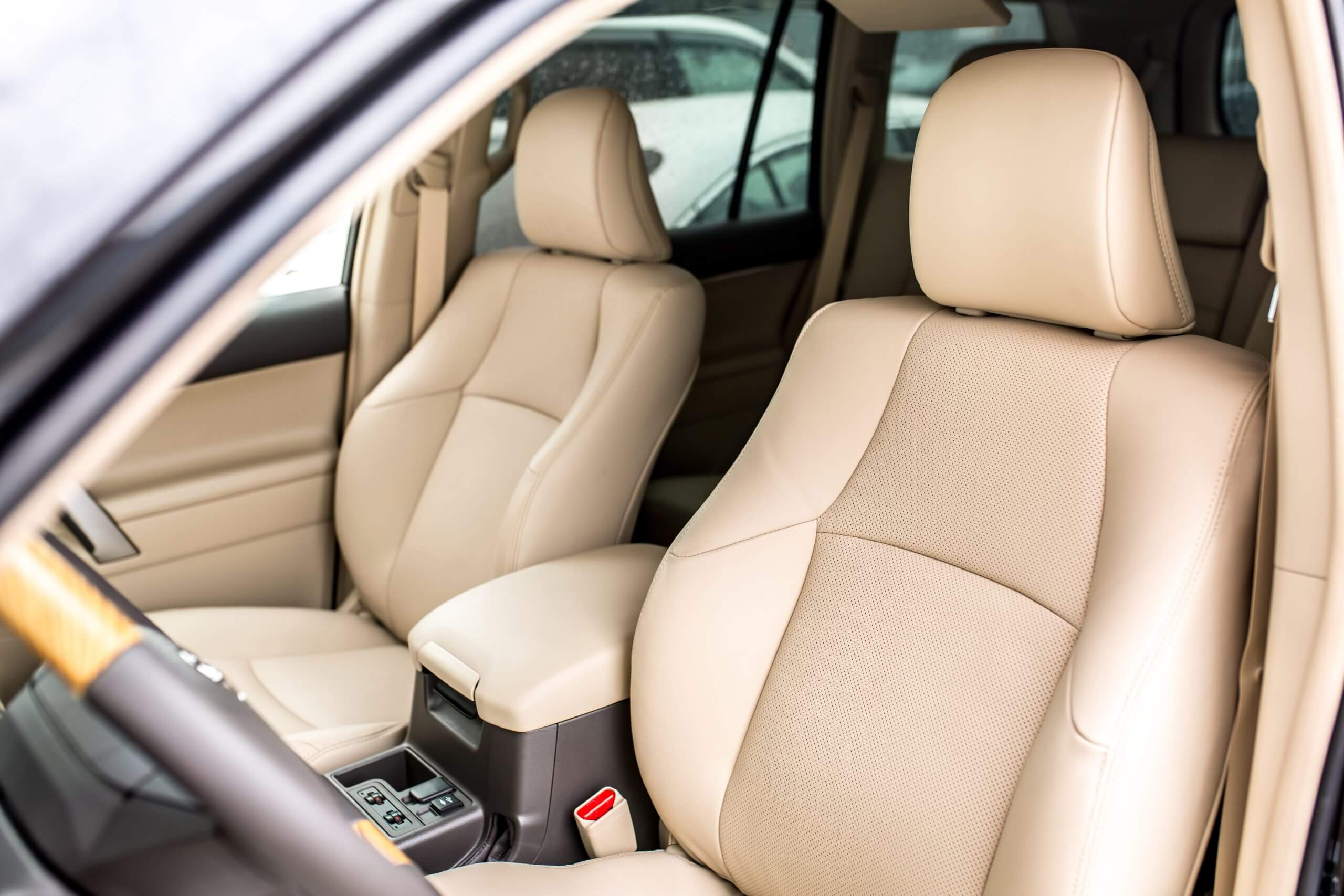 Luxurious beige leather car seats with modern design.