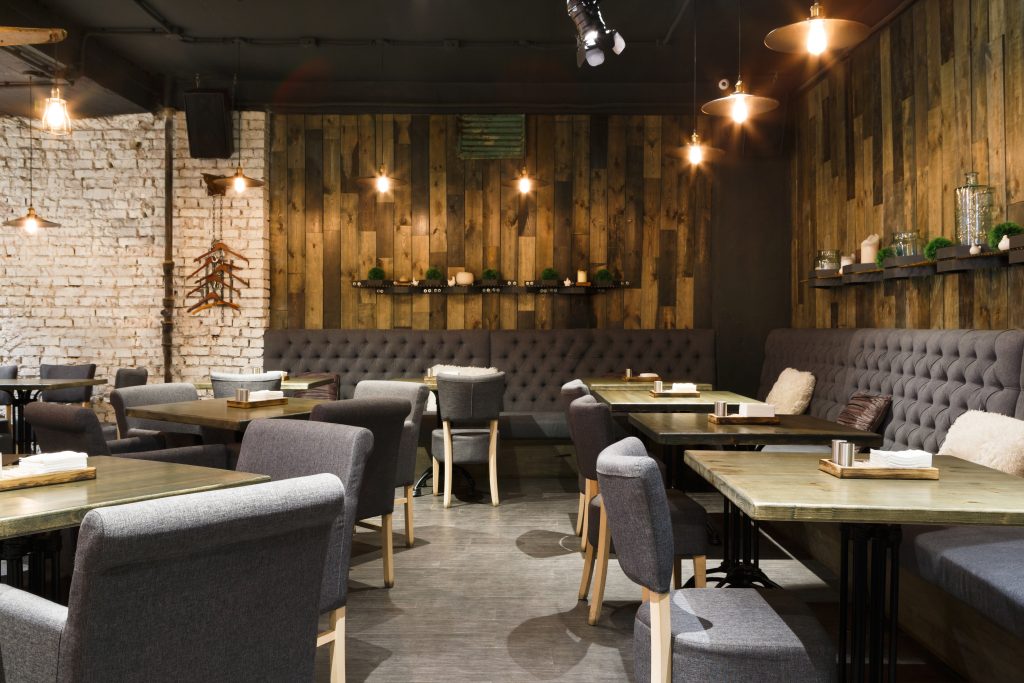 Cozy modern restaurant interior with wooden walls